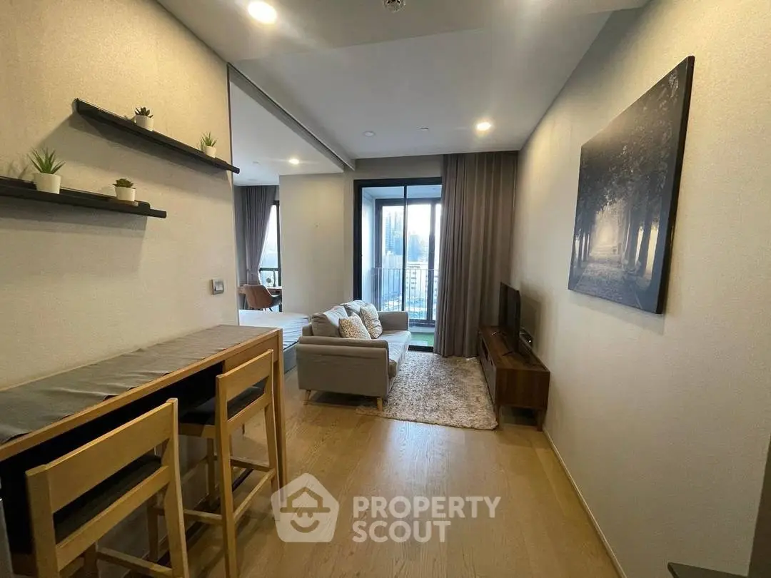 Modern living room with balcony view, stylish decor, and cozy seating area.