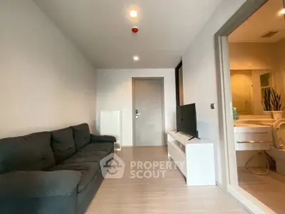 Modern living room with sleek design and cozy sofa, adjacent to a stylish bathroom.