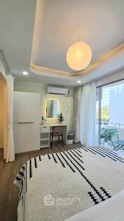 Modern bedroom with stylish decor and balcony view