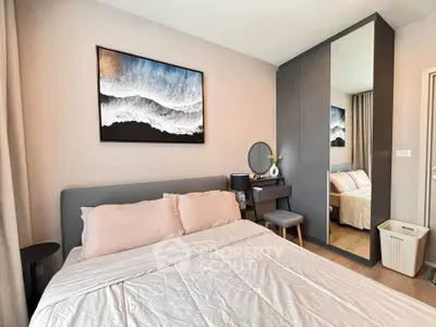 Modern bedroom with stylish decor and large mirror wardrobe