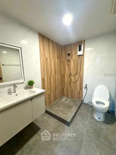 Modern bathroom with sleek shower and elegant fixtures in a contemporary apartment.