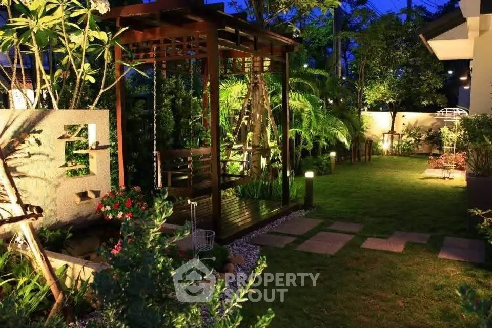 Charming garden with wooden pergola and lush greenery, perfect for relaxing evenings.