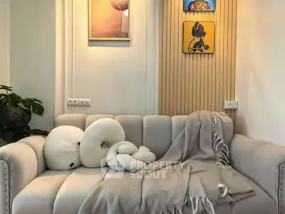 Cozy living room with plush sofa and stylish decor, perfect for relaxation.