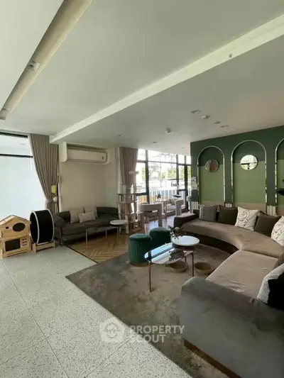 Spacious modern living room with stylish decor and ample seating, perfect for entertaining guests.