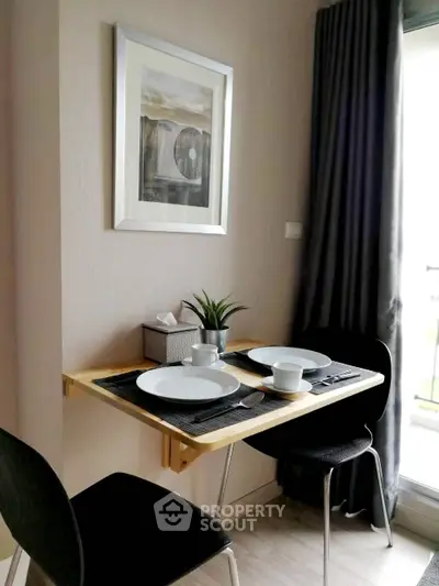Cozy dining nook with modern decor and natural light, perfect for intimate meals.