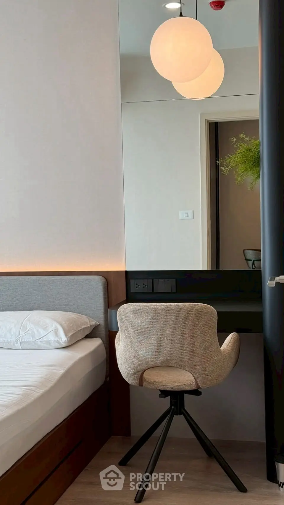 Modern bedroom with stylish chair and ambient lighting