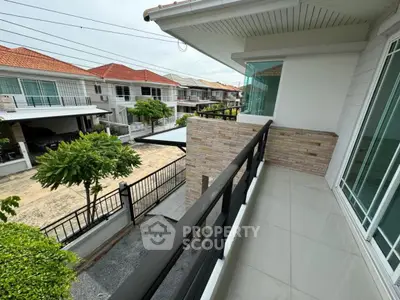 Spacious balcony with modern railing overlooking suburban neighborhood