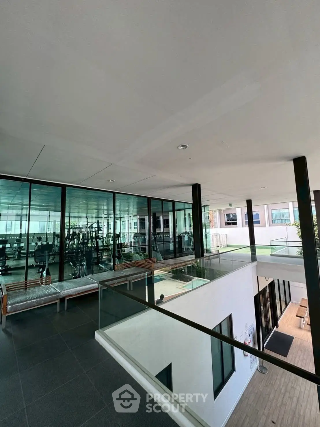 Modern gym with glass walls in a sleek residential building