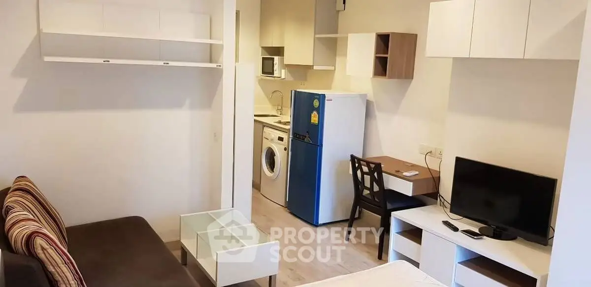 Chic modern studio apartment with compact kitchen and cozy living area, ideal for urban living.