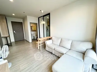 Modern living room with cozy sofa and wooden flooring in bright apartment