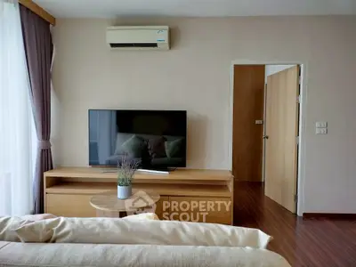 Modern living room with sleek TV setup and cozy decor