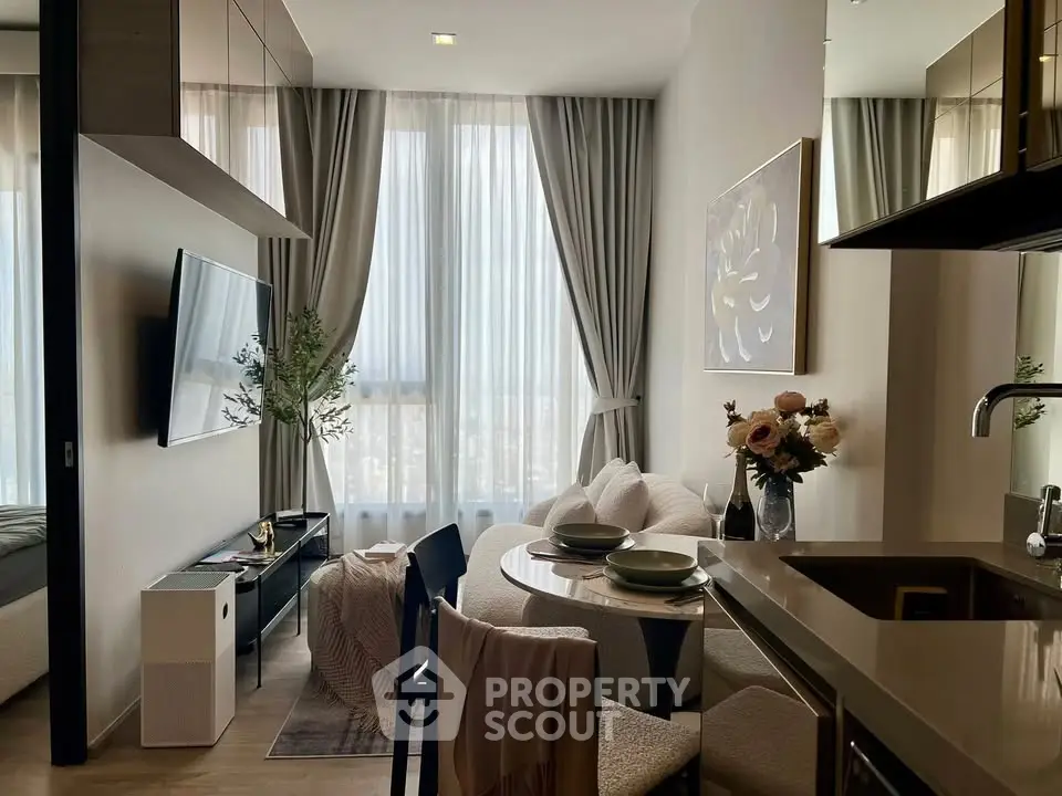 Modern living room with elegant decor and natural light, featuring a cozy dining area and stylish furnishings.