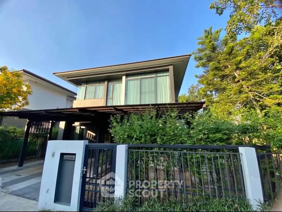 Modern two-story house with sleek design and lush greenery, perfect for contemporary living.