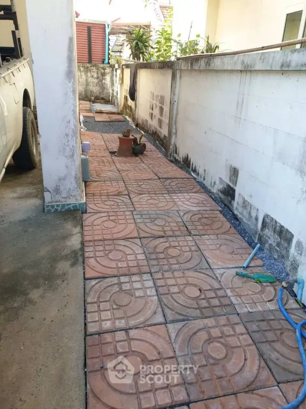 Spacious outdoor area with decorative paving and garden potential