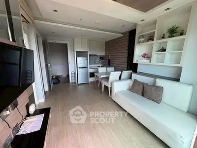 Modern living room with sleek furniture and open kitchen layout in a stylish apartment.