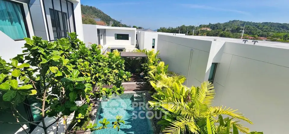 Luxurious modern villa with private pool and lush greenery, offering serene mountain views.