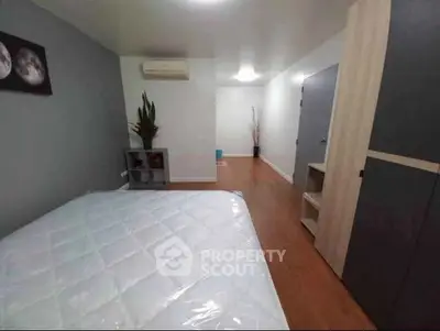 Spacious bedroom with modern decor and ample storage space