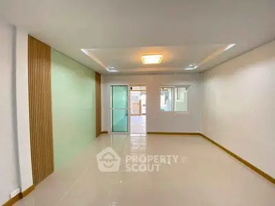 Spacious and modern living room with sleek design and ample natural light.