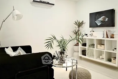 Modern living room with sleek black sofa and stylish decor