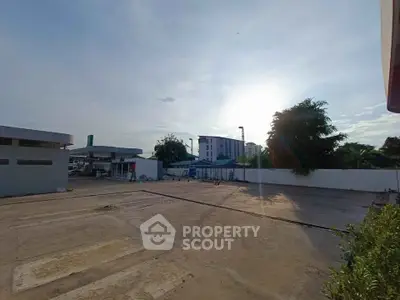 Spacious outdoor area with potential for development, featuring clear skies and surrounding greenery.