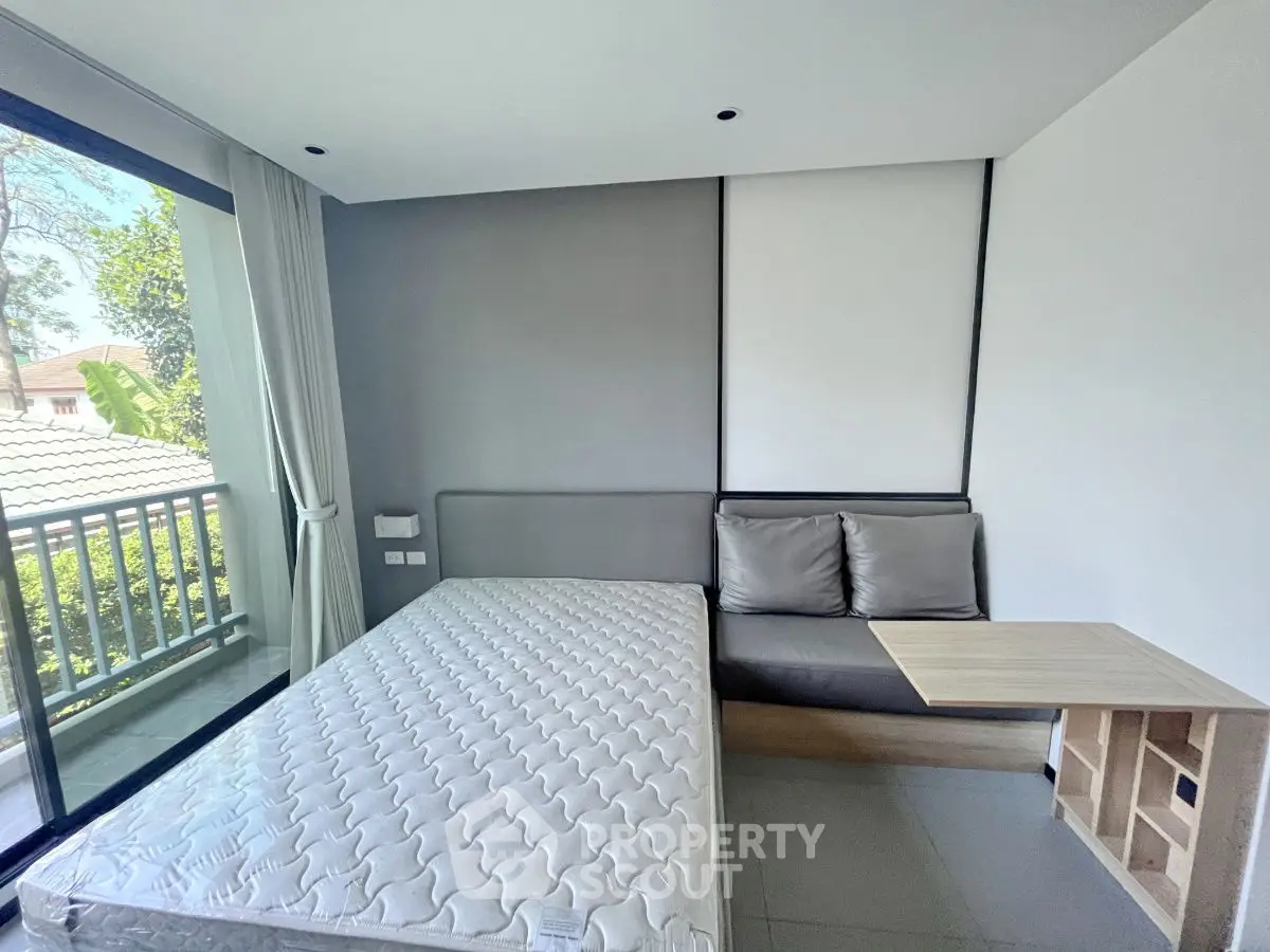 Modern bedroom with large window and minimalist decor
