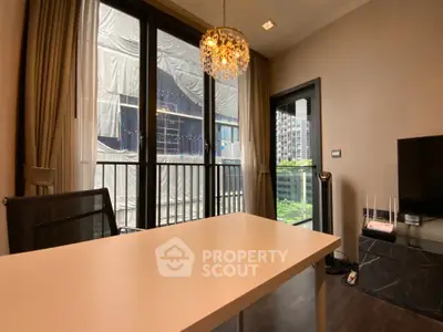 Modern study room with elegant chandelier and large windows offering city view