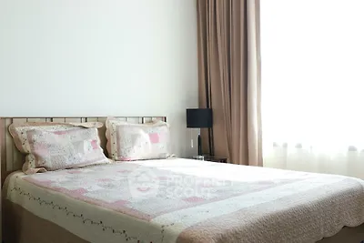 Cozy bedroom with soft lighting and elegant decor, featuring a comfortable bed and stylish curtains.
