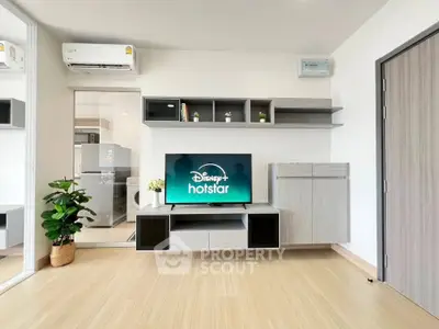 Modern living room with sleek furniture and entertainment setup, featuring a TV and stylish storage solutions.
