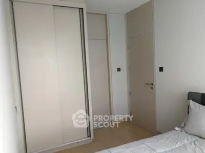 Modern bedroom with sleek sliding closet doors and minimalist design.