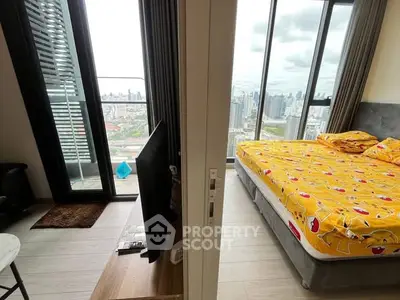 Modern bedroom with stunning city view and balcony access