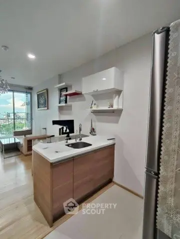 Modern kitchen with open layout and balcony view in stylish apartment