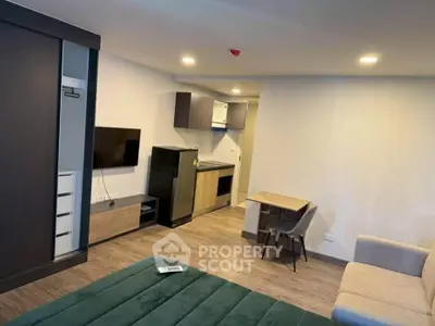 Modern studio apartment with sleek kitchen and cozy living area, perfect for urban living.