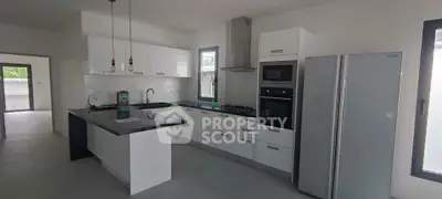 Modern kitchen with sleek white cabinetry and stainless steel appliances