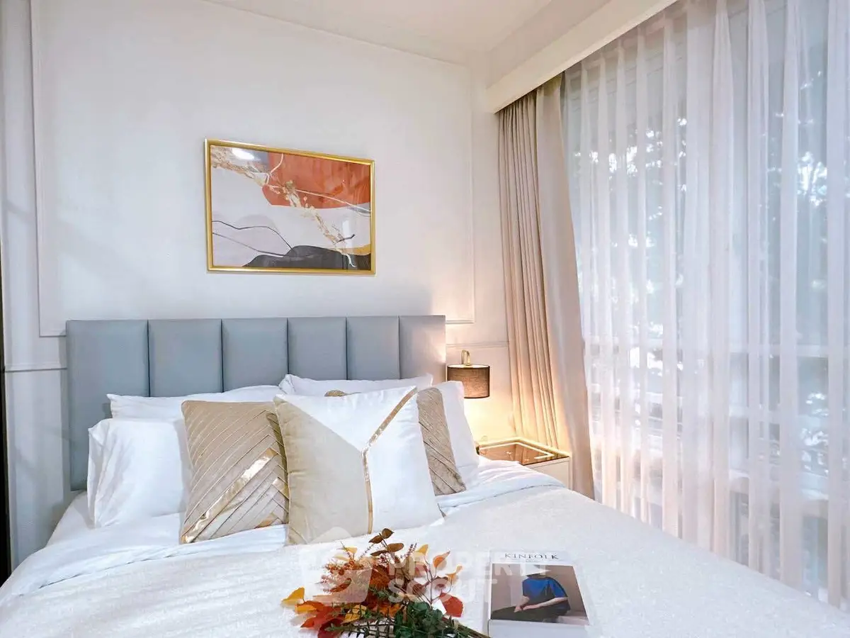 Cozy and elegant bedroom with modern decor and large window for natural light.