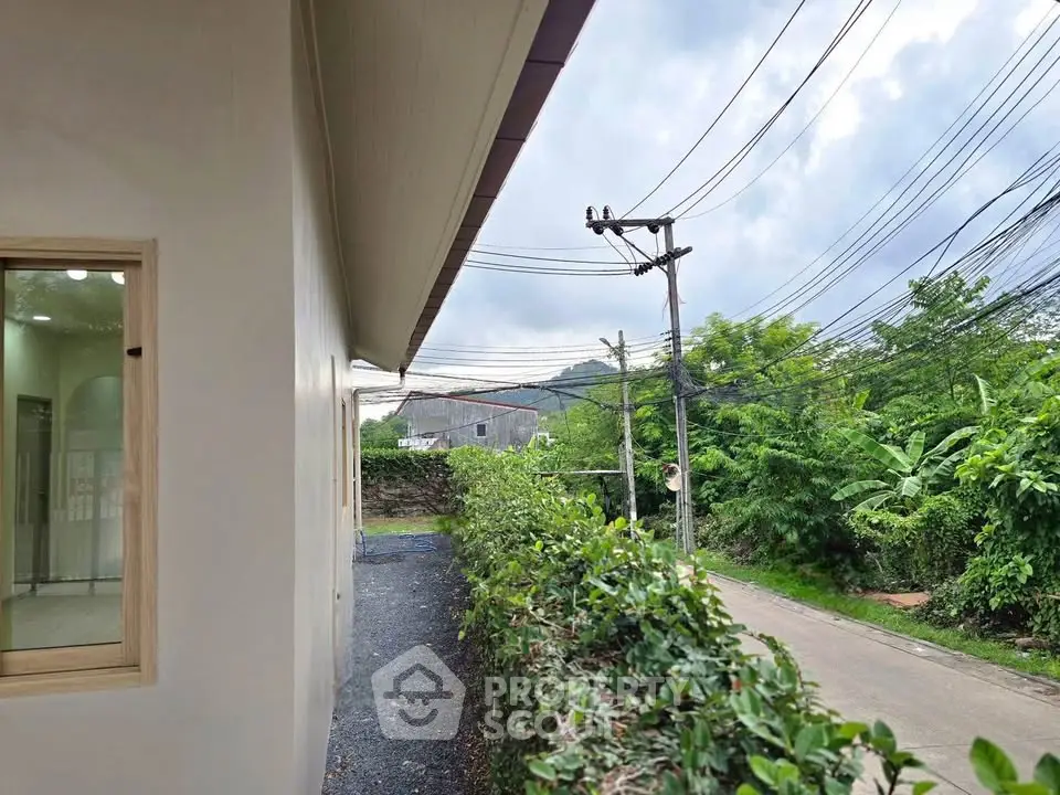 Charming residential property with lush greenery and scenic mountain views, perfect for nature lovers.