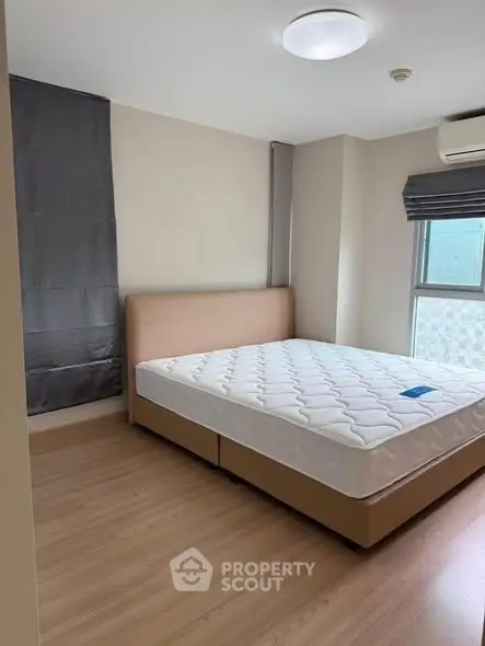 Modern bedroom with large window and minimalist design