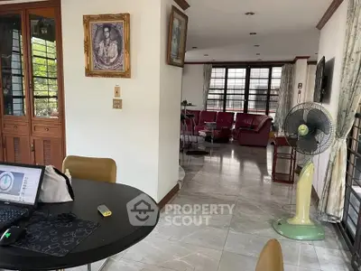 Spacious living area with modern furnishings and natural light, ideal for comfortable living.