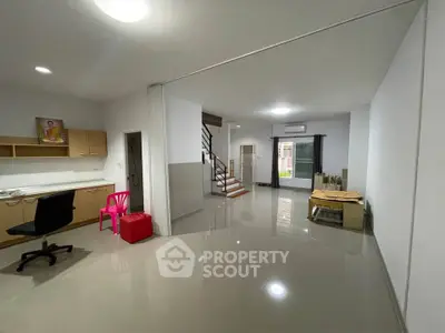 Spacious modern living area with sleek flooring and ample natural light