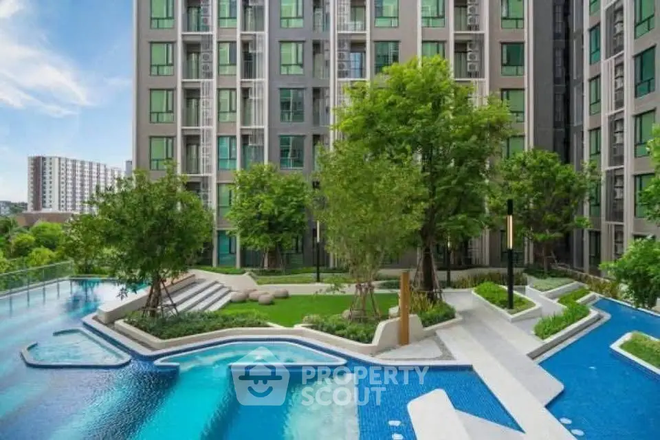 Luxurious condominium with stunning pool and lush garden view