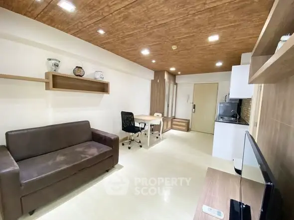 Modern living room with stylish wooden ceiling and open kitchen layout