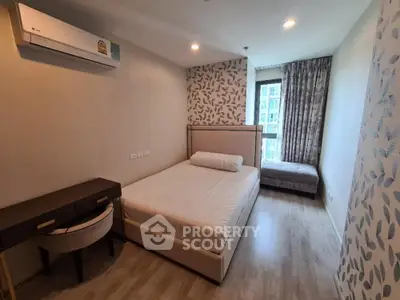 Modern bedroom with stylish decor and natural light, featuring a comfortable bed and work desk.