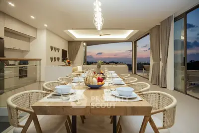 Luxurious open-plan dining area with stunning sunset views and modern decor.