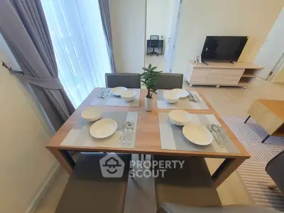 Modern dining area with elegant table setting in a bright, stylish apartment.