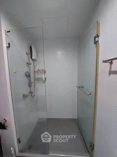 Modern bathroom with glass shower enclosure and sleek fixtures