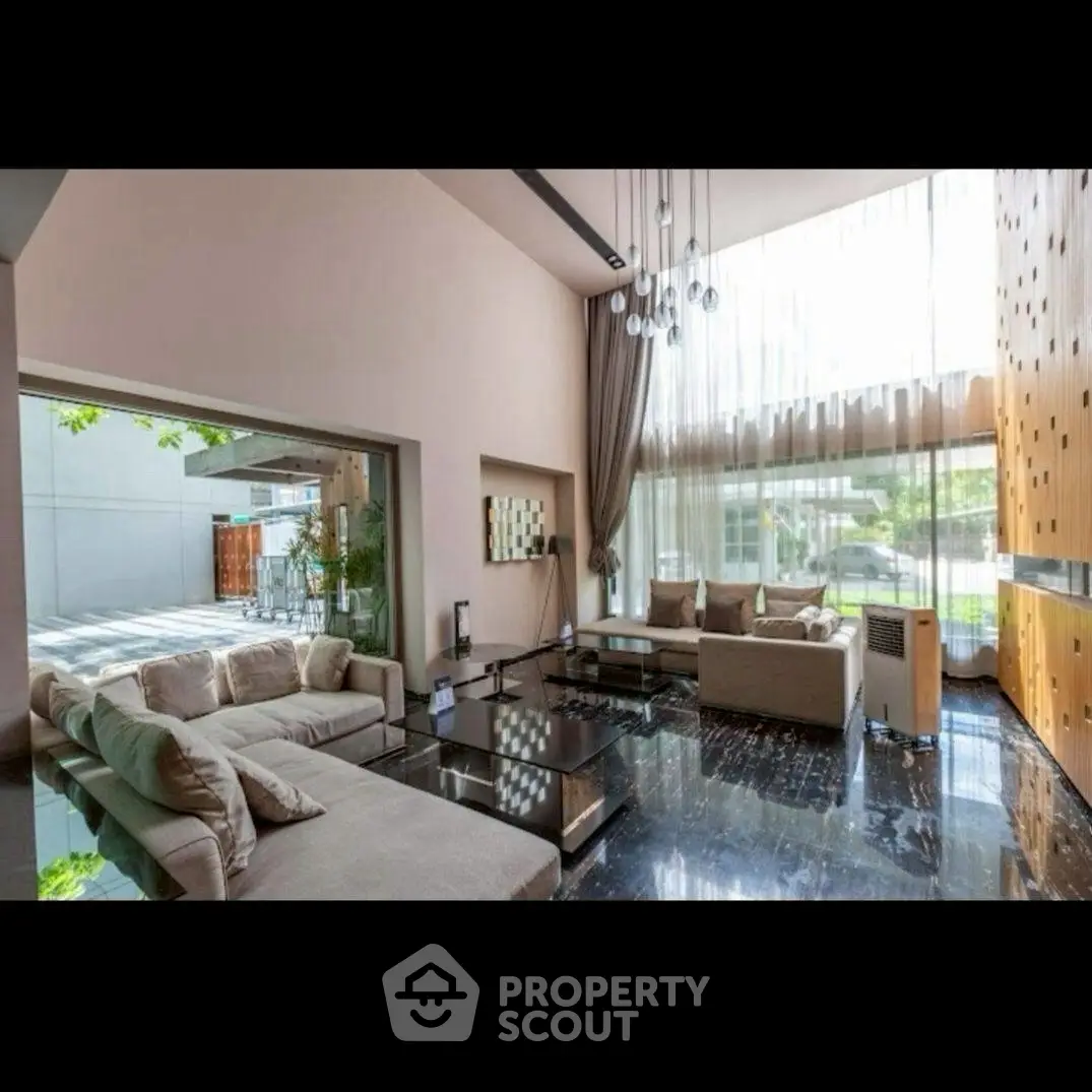 Luxurious modern living room with high ceilings and large windows