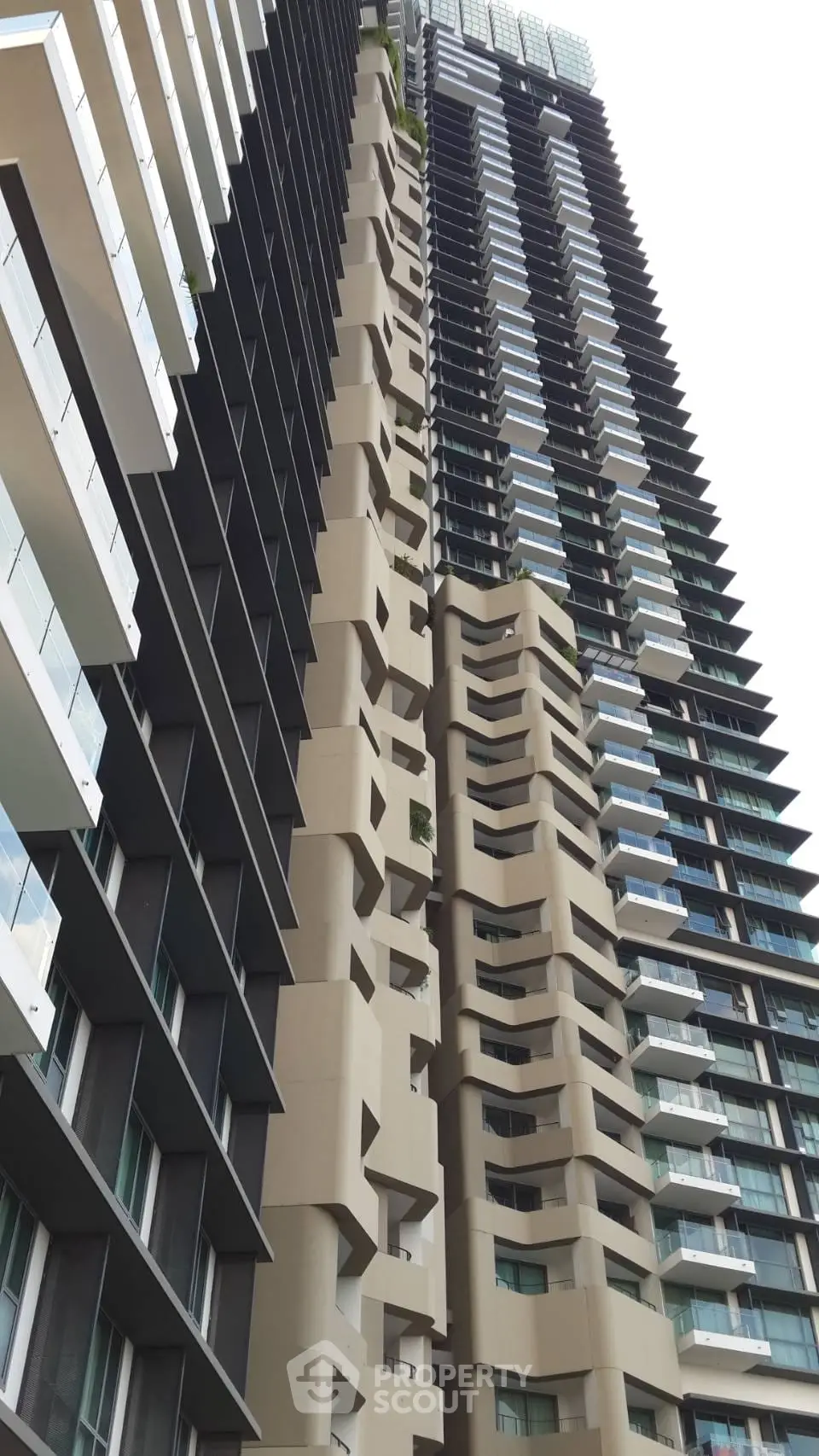 Stunning modern high-rise building with unique architectural design and expansive balconies.