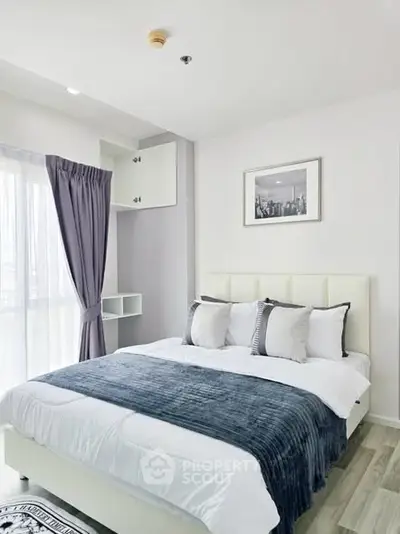 Modern bedroom with stylish decor and ample natural light