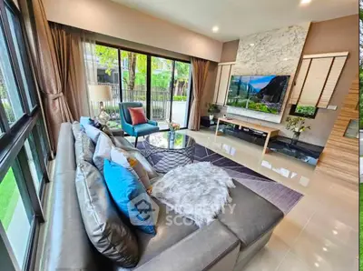 Luxurious living room with modern decor, large windows, and stylish furniture in a contemporary home.