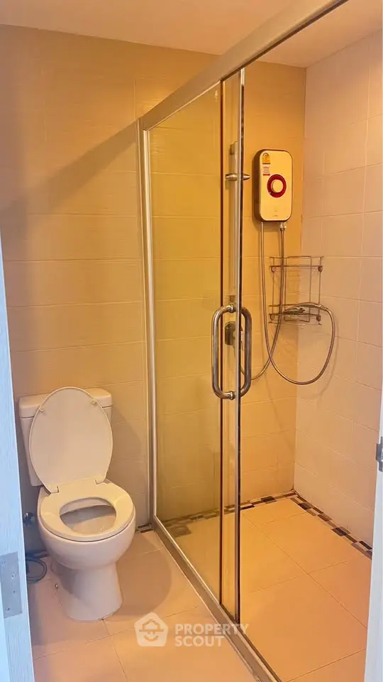 Modern bathroom with glass shower enclosure and sleek fixtures