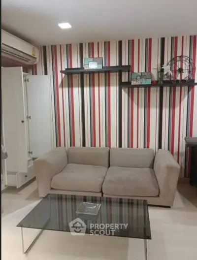 Stylish living room with modern striped wallpaper and cozy beige sofa